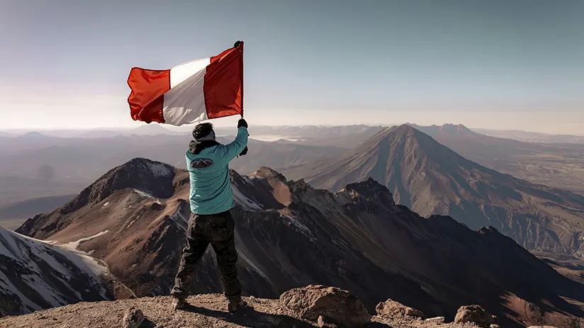 Panoramic view of Andes and Peruvian flag